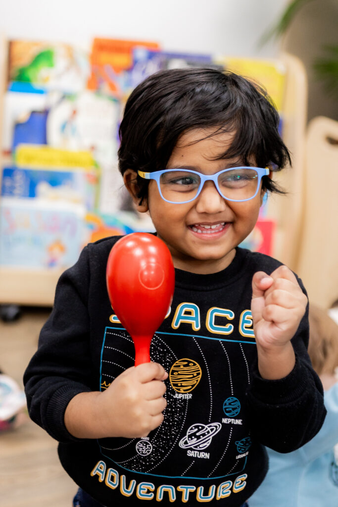 Child with Maraca at Molly Moocow class