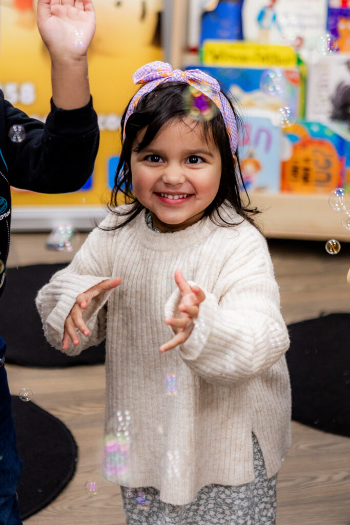 Child with bubbles at Molly Moocow class